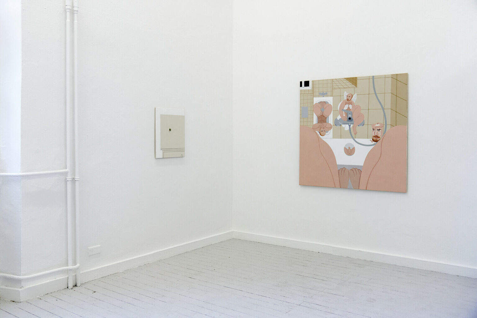 Foto: Eine Raumecke mit weißen Wänden und grauem Dielenboden. An der Wand hängen zwei Leinwände im Mittel- und Kleinformat.